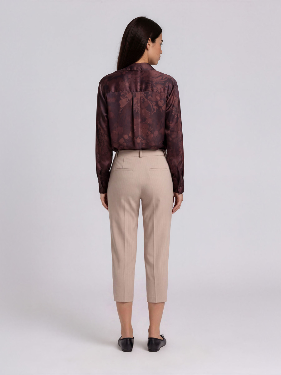 Trousers with pleat detail near the pocket